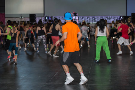 Workout at Gym: Boy with Hat Exercising with Music in Fitness Class.のeditorial素材