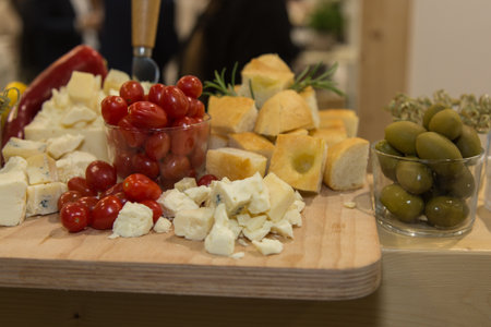 Fresh Cherry Tomatoes, Pieces of Cheese, Green Olives and Focaccia Cuts.の写真素材