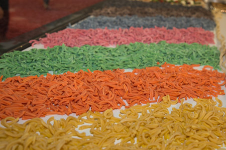 Display of a Food Store with Various Rows of Raw Coloured Pasta.の写真素材