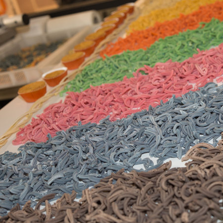 Display of a Food Store with Various Rows of Raw Coloured Pasta.の写真素材