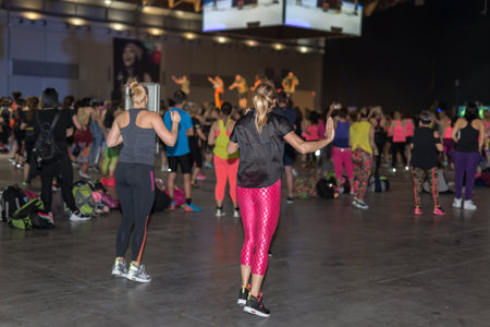 Fitness Workout in Gym: People doing Exercises in Class with Music and Teacher on Stage.の写真素材