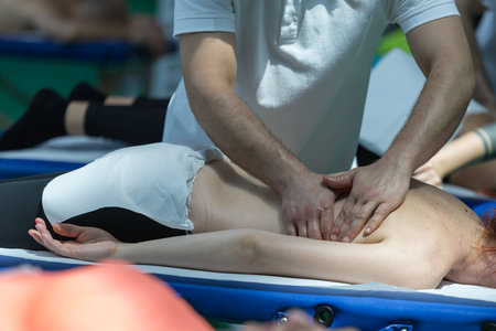 Athlete's Back Professional Massage on Bed after Sport Fitness Activity.の写真素材