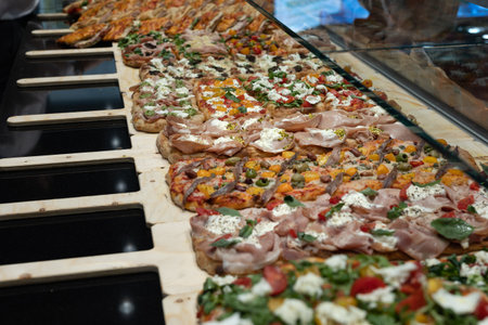 Display of a Bakery Counter with Stuffed Pizzas in many Tastes.の写真素材