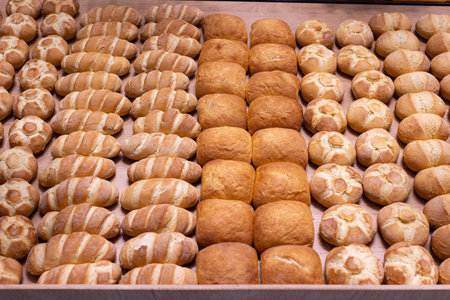 Various Types of Bread Buns displayed Orderly on Top of a Wooden Display Stand from an Italian...