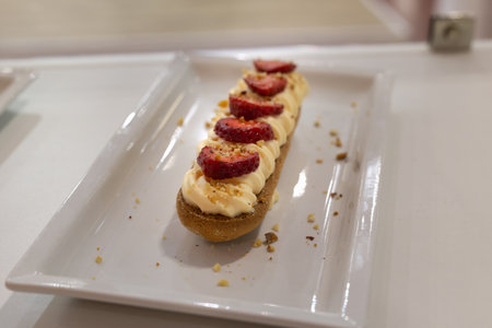 Savoy Cookie filled with Cream, Seasonal Strawberries and Hazelnut Crumbs.