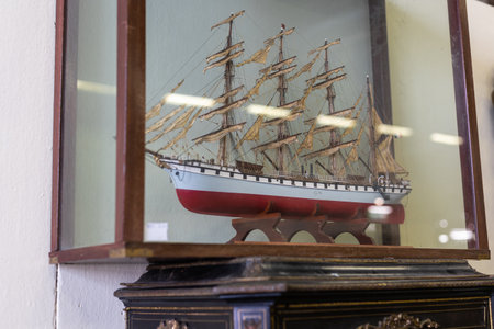 Miniature of an Antique Hand-built Sailing Vessel Preserved inside a Glass Case.の写真素材