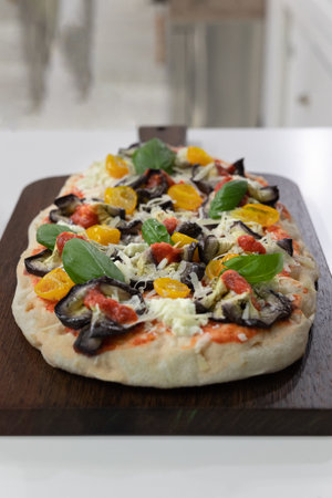 Vegetarian Pizza Stuffed with Basil, Tomatoes, Eggplant and Cheese.の写真素材