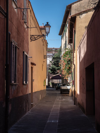 Narrow Street with Ancient Walls and antique Lamp Post in Pisa, Tuscany - Italy.の写真素材