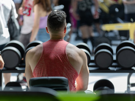 Boy Doing Exercises with Dumbbells in the Gym: Fitness Workout.の写真素材