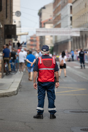 Security and Traffic Control Officer with His Paddle during an Event in a City Street.の写真素材
