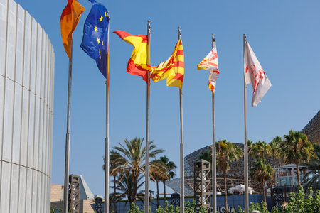 Flags waving against Blue Sky Outside Public Building.の写真素材