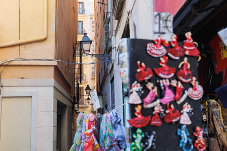 Typical Narrow Barcelona street with Old Street Lamps and Featured Souvenir Shop.の写真素材