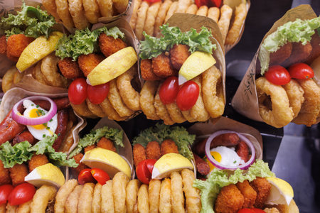 Containers Ready for Quick Food Consumption with Fried Fish accompanied with Lemon, Onion and Tomatoes.の写真素材