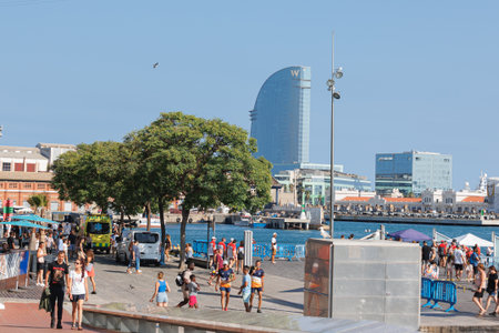 A Street Close to the Port of Barcelona with People, Tourists, Trees and Bauildings in the background, Spain.の写真素材