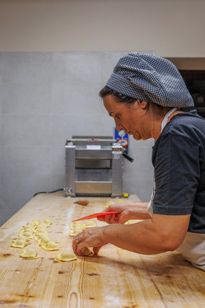 Preparing Italian Stuffed Tortelli on a Long Wooden Table.の写真素材