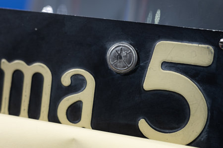 Fascist-era Fascism Logo Stamp on a number Plate of a Classic Car.