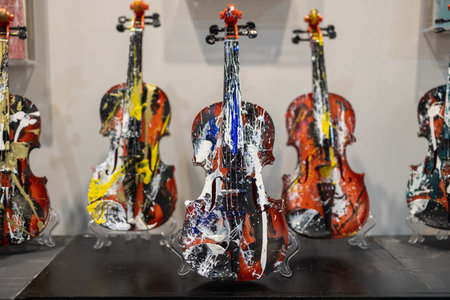 Hand-Painted Colorful Violins in a Modern Art Installation.の写真素材