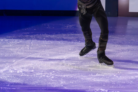 Detail of the Legs and Ice Skates of a Skater Performing his Artistic and Technical Performance on...