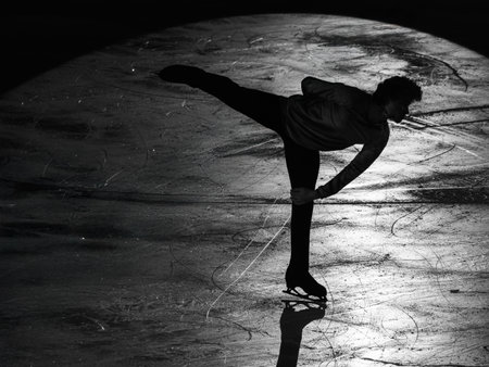 Backlight of an Athlete Skater and the Shadow reflected on the Ice Rink during the Artistic and Technical Performance.の写真素材