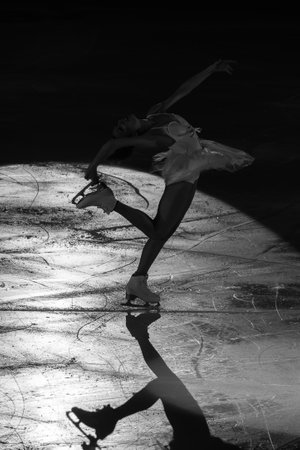 Backlight of an Athlete Skater and the Shadow reflected on the Ice Rink during the Artistic and Technical Performance.の写真素材