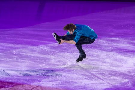 Young Skater Performing at Spin on the ice Rink.の写真素材