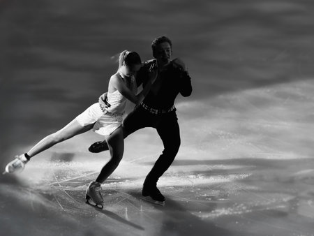 Backlight of a Skating Athlete Couple and their shadow reflected on the Ice Rink during the Artistic and Technical performance.の写真素材