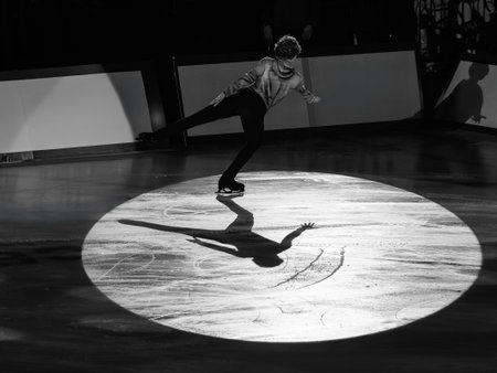Backlight of an Athlete Skater and the Shadow reflected on the Ice Rink during the Artistic and Technical Performance.の写真素材