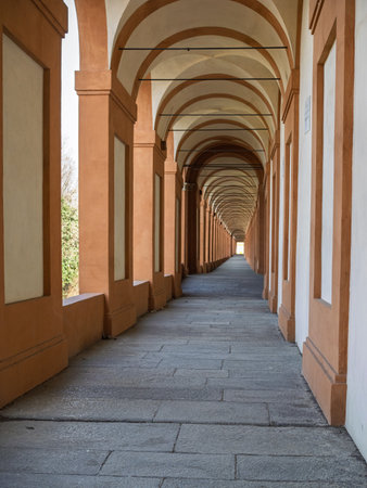 Historical Portico Covered Walkway with People Leading To San Luca Shrine, Bologna - Italy.の写真素材