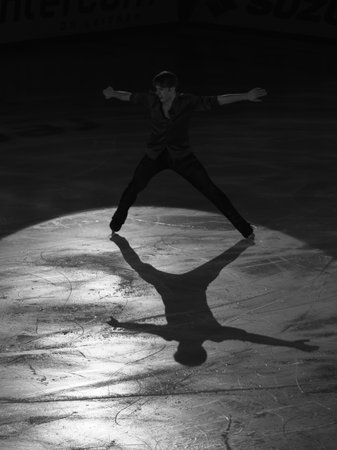 Backlight of an Athlete Skater and the Shadow reflected on the Ice Rink during the Artistic and Technical Performance.の写真素材