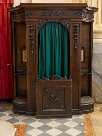 Wooden Traditional Confessional with Curtain inside a Historic Church.の写真素材
