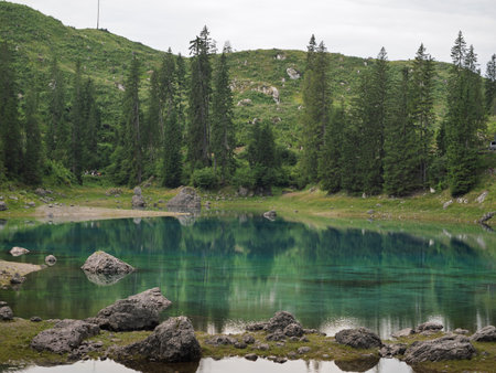 Stunning View Of Emerald Water Of Lake Carezza with Beautiful Mountain Reflection, Italy.