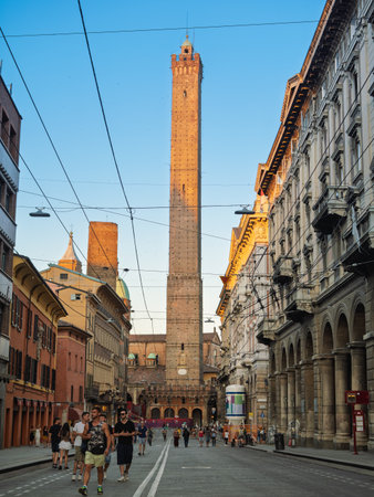 Asinelli And Garisenda Towers Dominating Bologna Skyline With Historic Buildings And People - Bologna, Italy.の写真素材