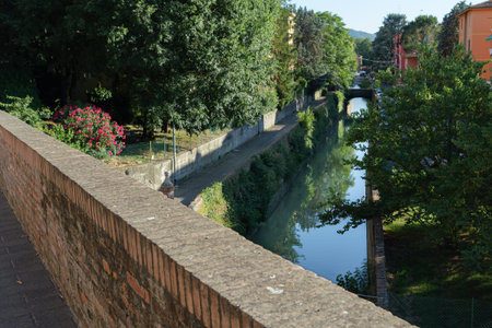 Sunny View Of Historic Canal And Lush Greenery, Bologna, Italy.の写真素材