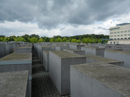 Concrete Slabs Of The Berlin Holocaust Memorial Under A Cloudy City Sky, Berlin - Germany.の写真素材