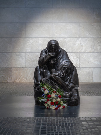 A Solemn Statue In Berlin Memorial, the Grieving Mother At Neue Wache, Mother Holding Her Dead Son In Stone in Berlin Germany.の写真素材
