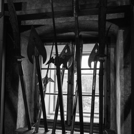 Black And White View Of Medieval Polearms Standing By An Old Window In A Dark Room, Prague, Czech Republic.の写真素材