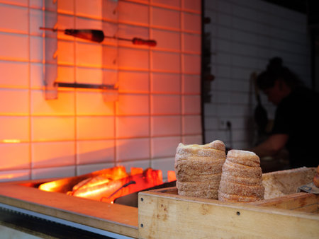 Two Freshly Baked TrdelnÃ­k Sweet Bohemian Pastries Are Resting In A Wooden Crate Near The Orange...