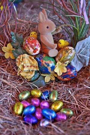 an Easter bunny with Easter eggs in a nest of straw