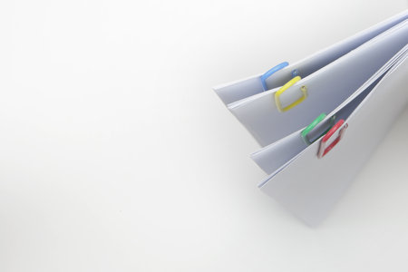 four paper clip hold together some white sheets of paper