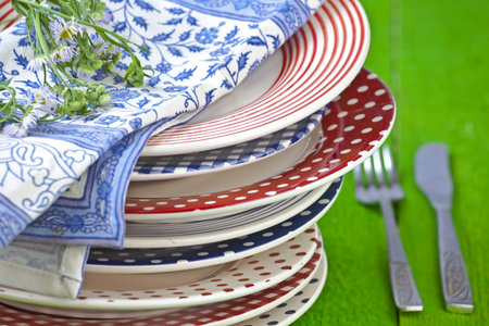 rustic and colorful plates on a green wooden table