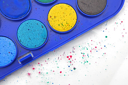 paint box with water-colors and splashes of paint