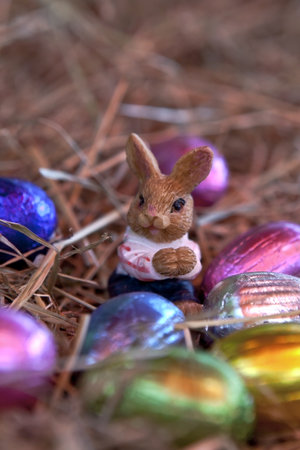 an Easter bunny with Easter eggs in a nest of straw