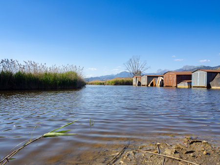 Abandoned iron shacks along the shore of the lakeの写真素材
