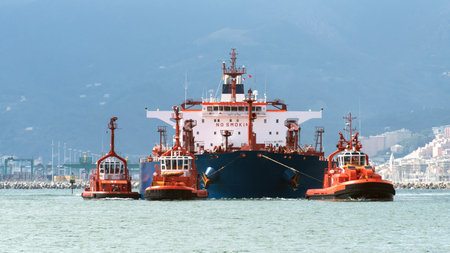 tugs in action with the tankerのeditorial素材