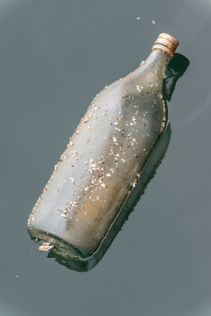 bottle that pollutes the sea surfaceの写真素材