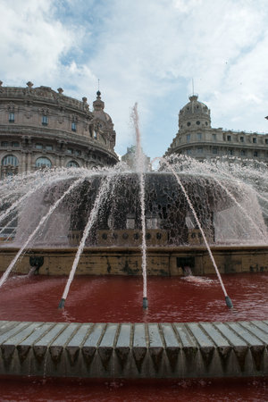 The water of the fountain in Piazza De Ferrari was colored redの写真素材
