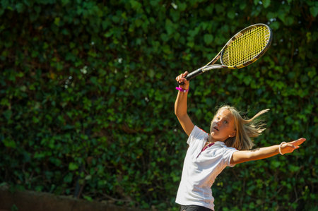 Children at school during a dribble of tennisの写真素材