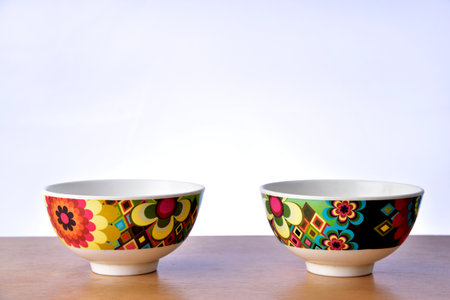 Colorful bowls on the table on white background.の写真素材