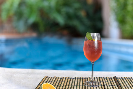refreshing red berry drinck by the pool with sunny day.