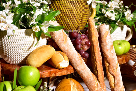 Composition with groceries in wicker basket on kitchen tableの写真素材
